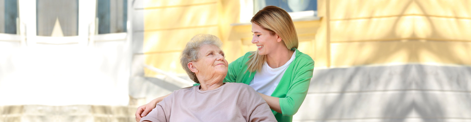 caregiver and her patient smiling at each other